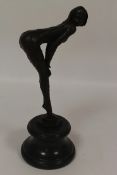 A bronze figure depicting an Art Deco style lady leaning forward, on marble plinth, height 34.5