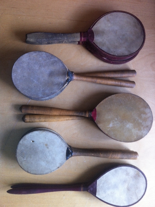 TABLE TENNIS, five pairs of early vellum bats, all with turned wooden handles, splits to vellum (4),