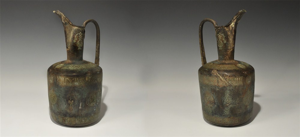 Islamic Bronze Silver-Inlaid Calligraphic Jug 12th century AD . A bronze jug with broad body, deep