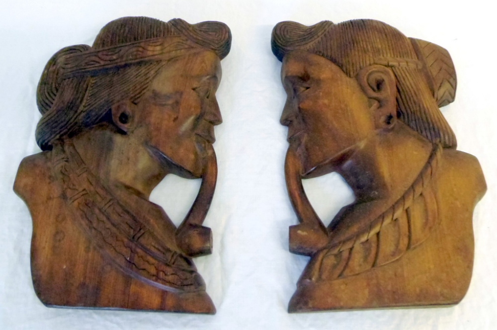 Pair of Indonesian carved wall hangings of heads