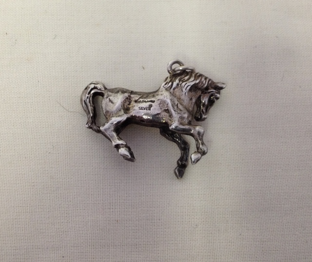 Silver hall marked pendant of a horse