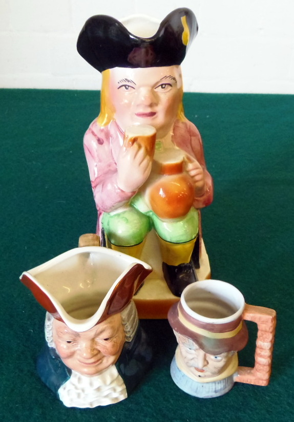 Toby jug holding jugs and two smaller Toby jugs