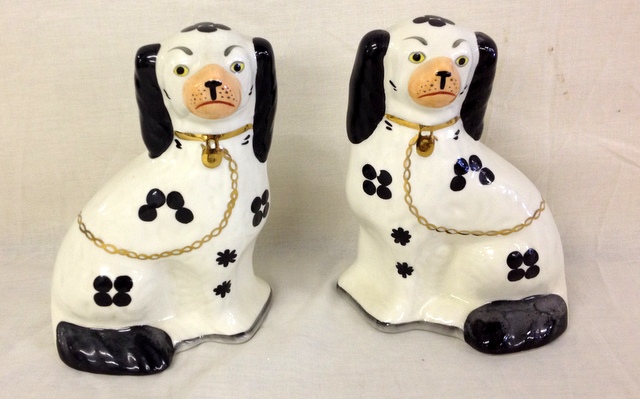 A pair of Staffordshire pottery dogs