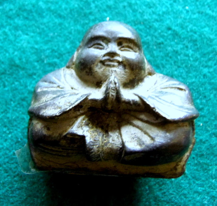 Small aged bronze Buddha.