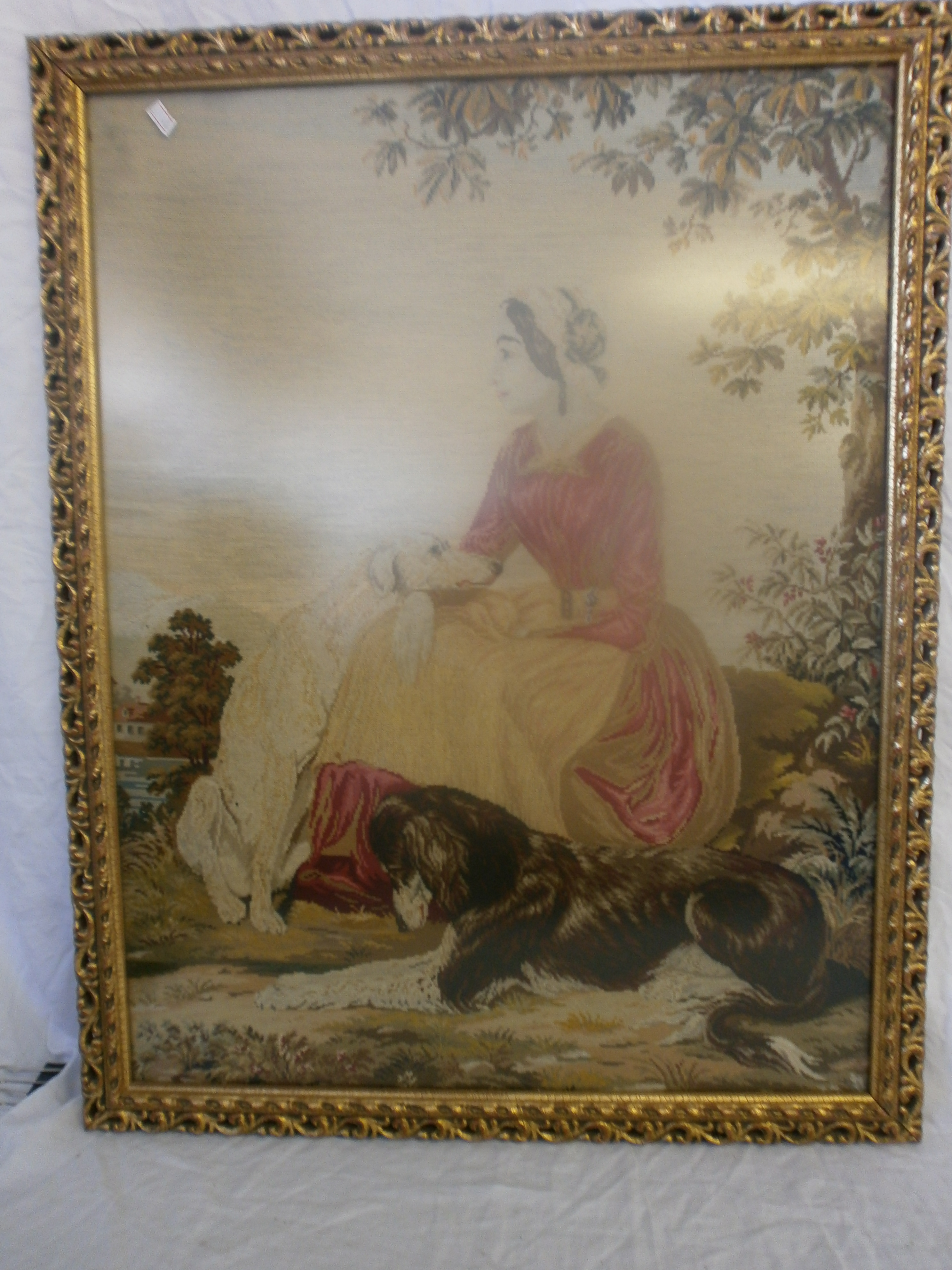 Embroidery picture of a woman with dogs.