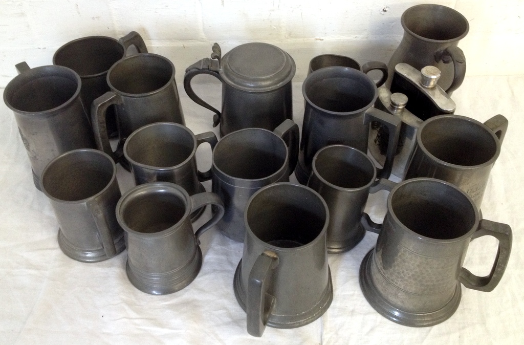 Pewter mugs and two hip flasks.