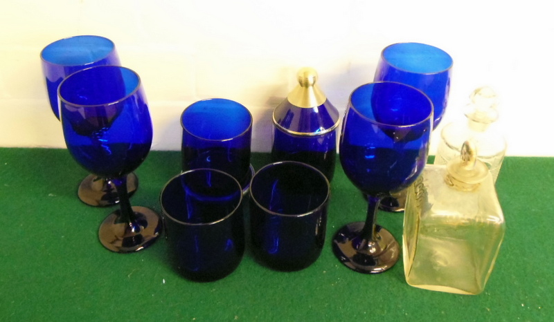 Eight pieces of blue glass and two glass bottles