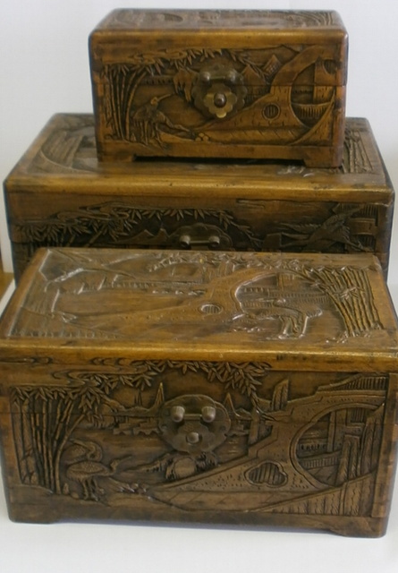 Three carved wooden boxes of reducing size