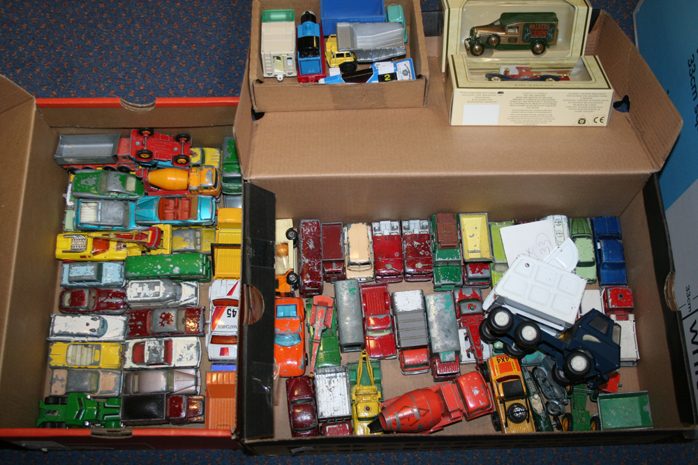 A collection of Matchbox cars and commercial vehicles, two Britains field guns, two motorcycles