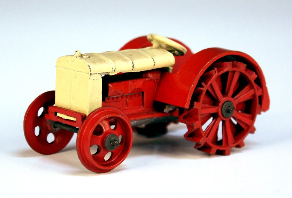 A Dinky Toys No. 22e farm tractor, finished in cream and red (some paint chips).