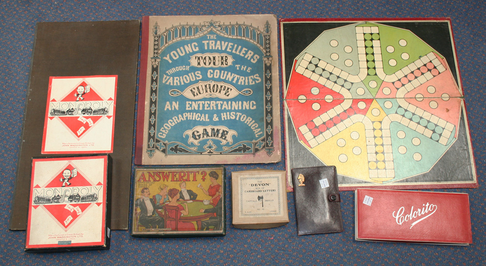 A collection of games and toys, including Dover Patrol, Aviation, Monopoly, playing cards, card