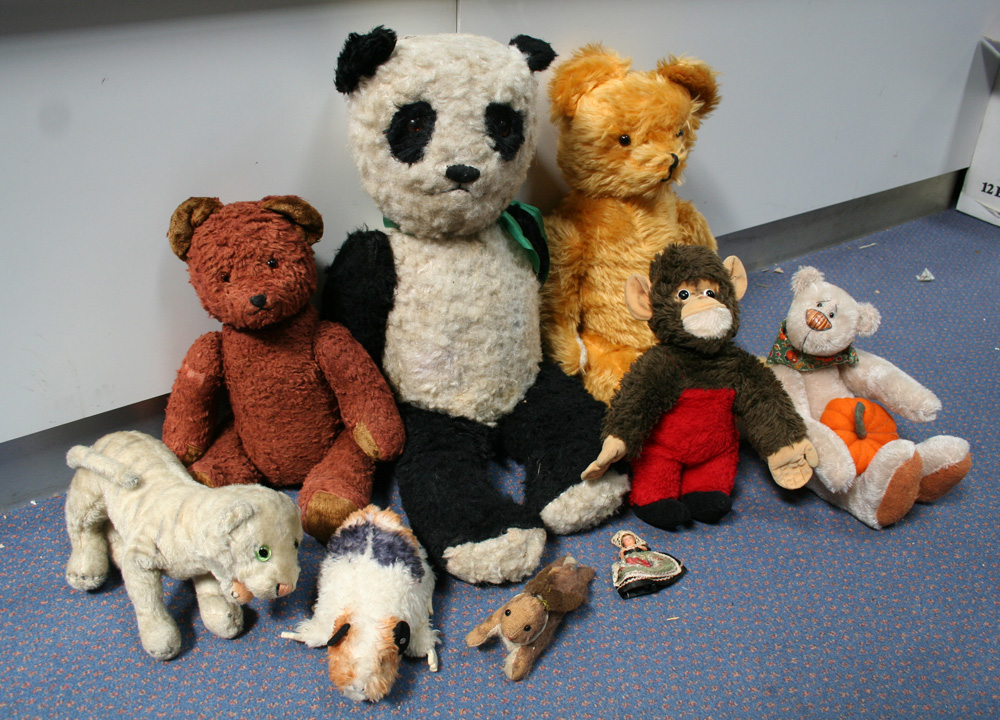 A Steiff soft toy guinea pig, a soft toy panda bear and other soft toys.