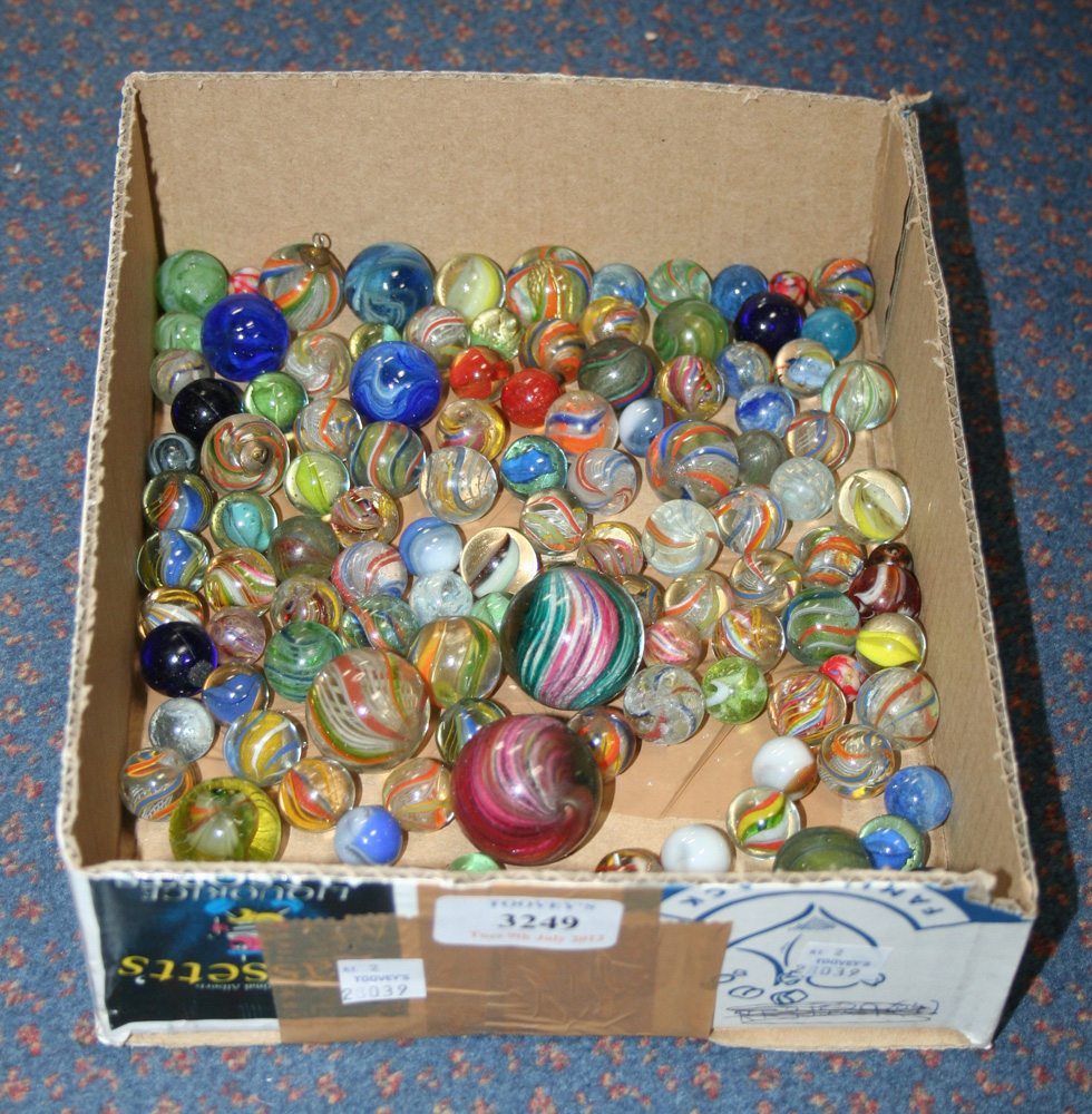 A collection of marbles, some with vari-coloured swirls and lattice, including three larger examples