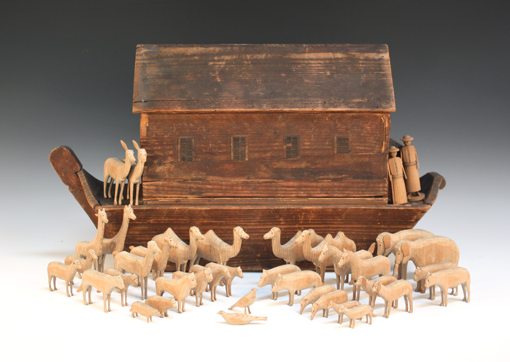 A late 19th/early 20th Century Noah`s ark with pitched roof and removable side panel, length