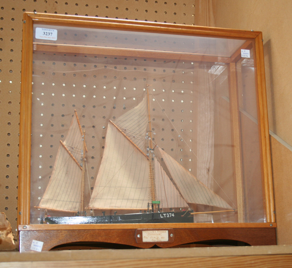 A model of a two masted fishing boat, within a display case inscribed `Trawling Tosher "Magnolia",