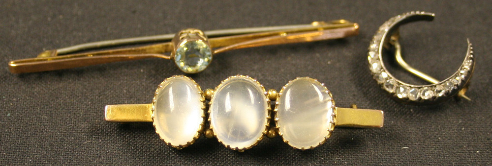 A rose diamond set brooch designed as a crescent, a gold and moonstone set three stone bar brooch,