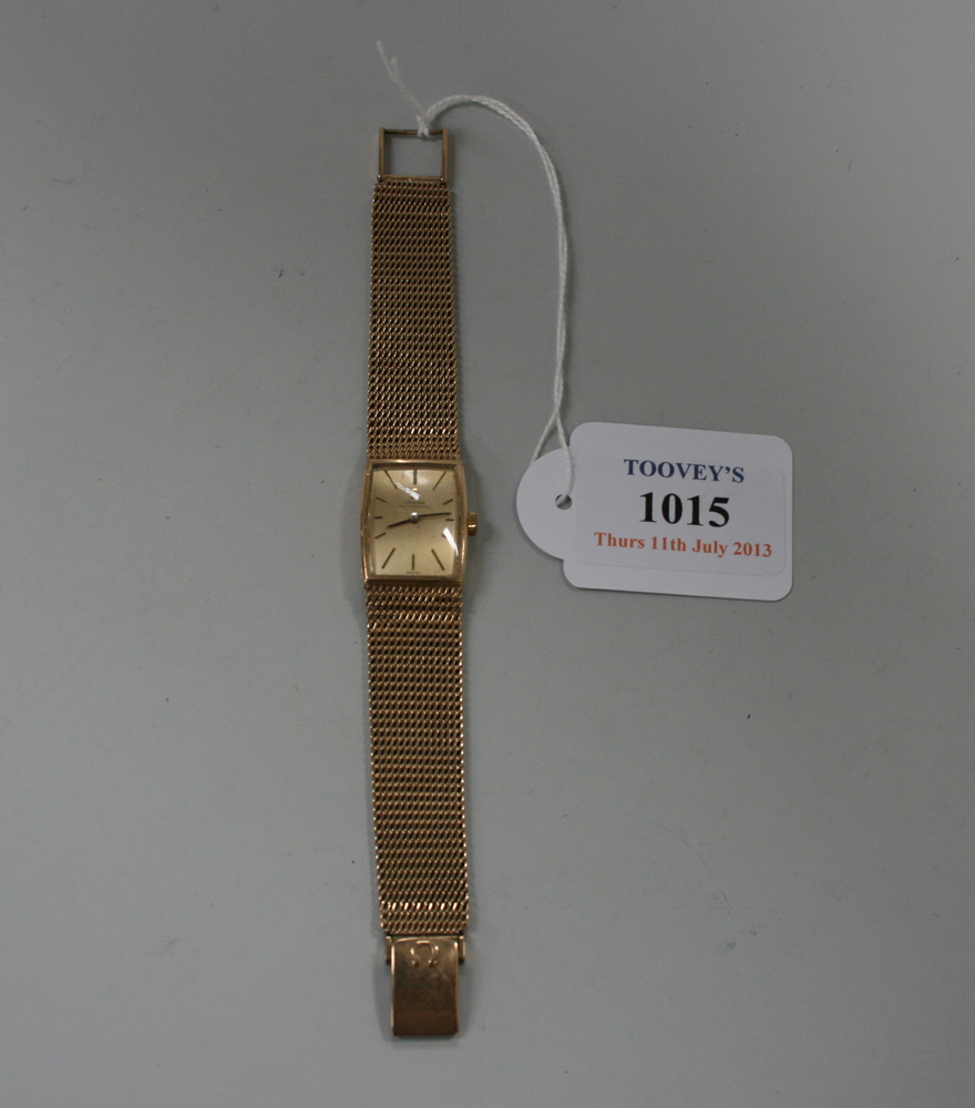 An Omega Automatic 9ct gold lady`s wristwatch, the waisted rectangular gilt signed dial with thin