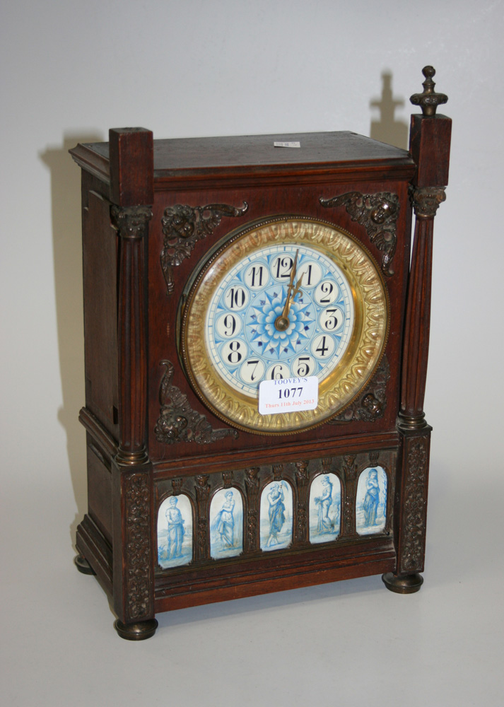 A late 19th Century walnut cased mantel clock with eight day movement striking on a gong, the