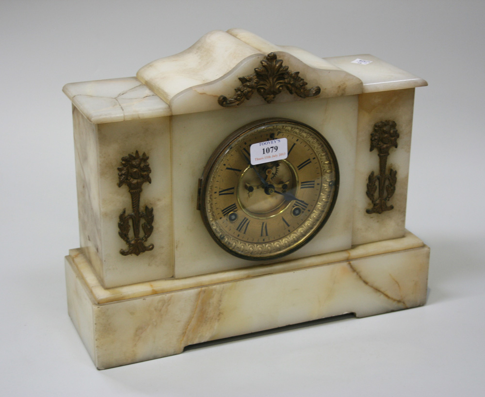 A late 19th/early 20th Century onyx cased mantel clock with eight day movement striking on a gong,