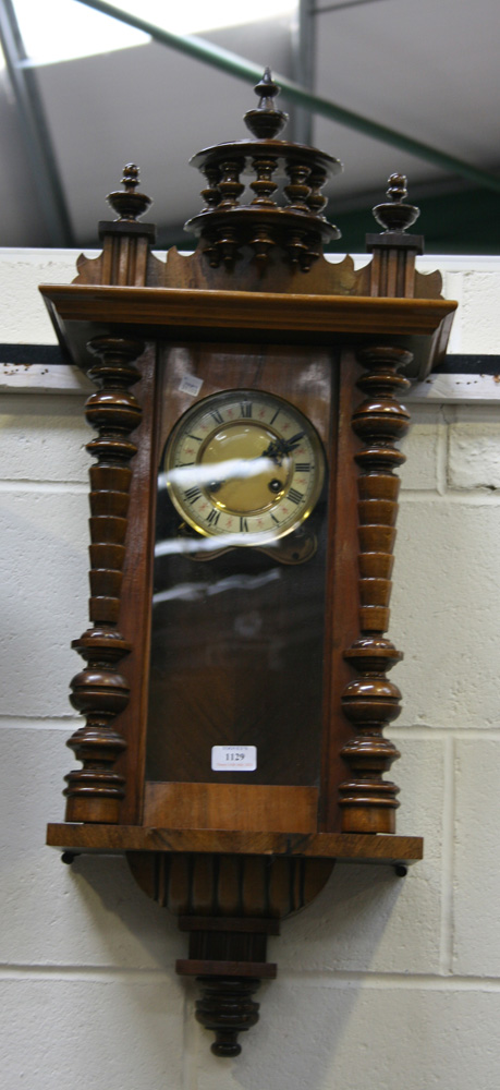 A late 19th Century walnut cased Vienna style wall clock with eight day movement striking on a gong,