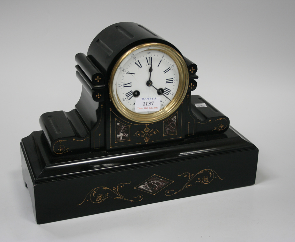 A late 19th Century slate mantel clock with eight day movement striking on a gong, the circular