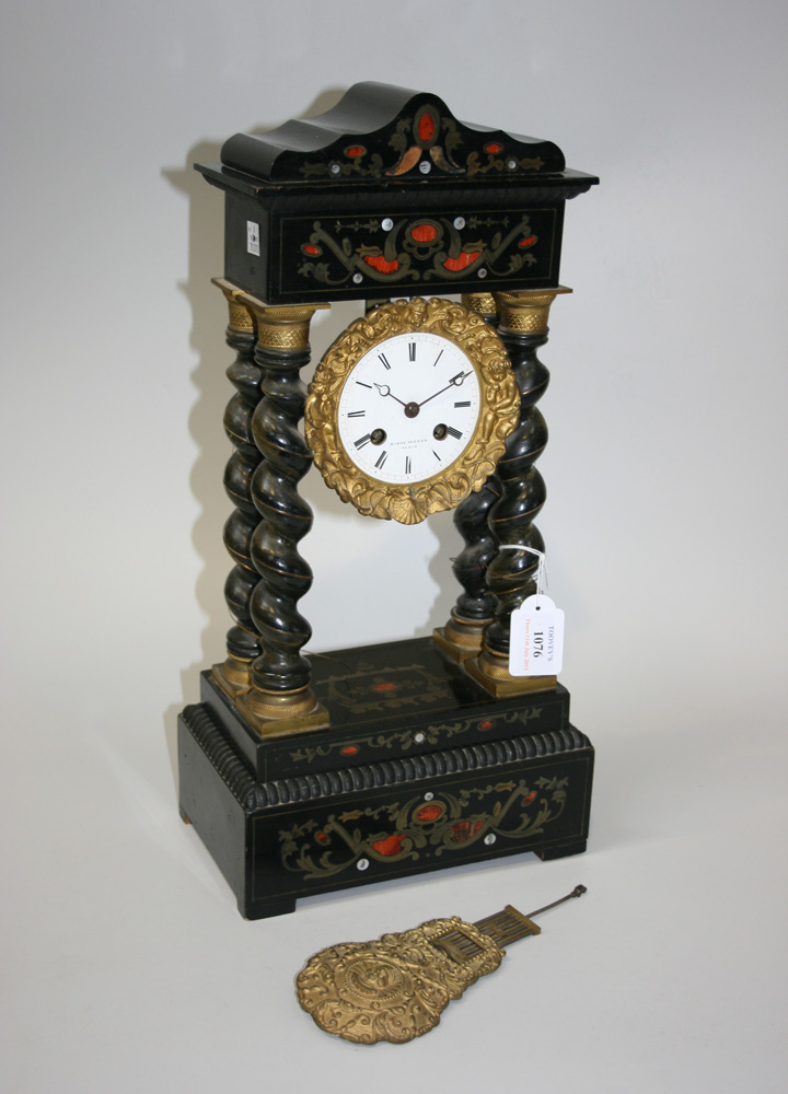 A late 19th Century ebonized and brass inlaid portico clock with eight day movement striking on a