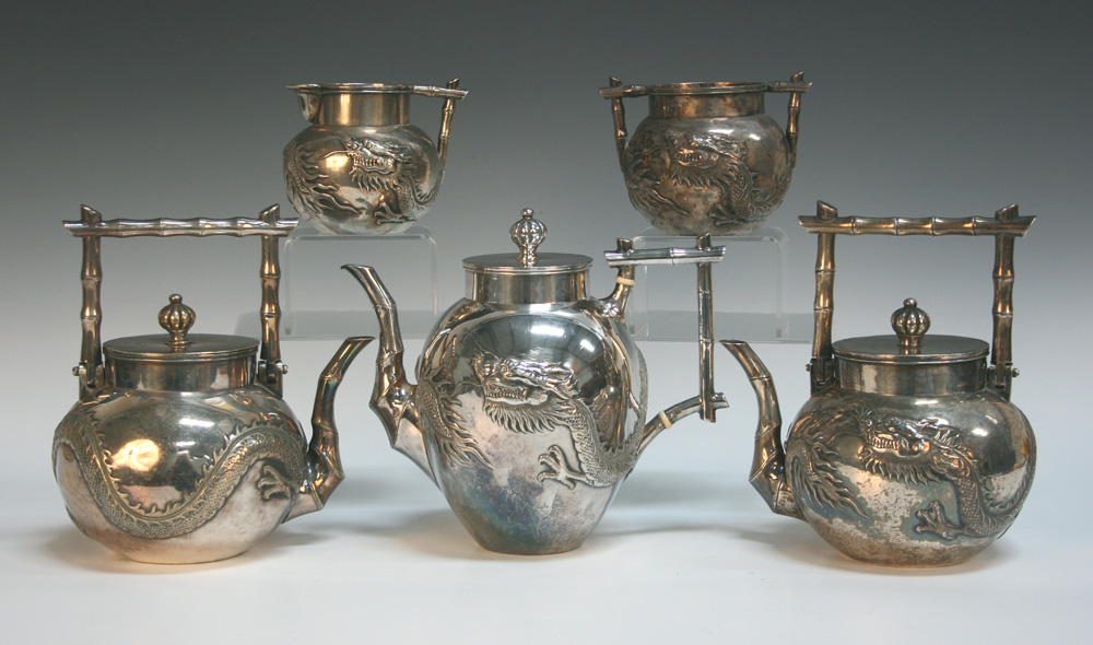 An early 20th Century Chinese silver three piece tea set, comprising teapot and cover with