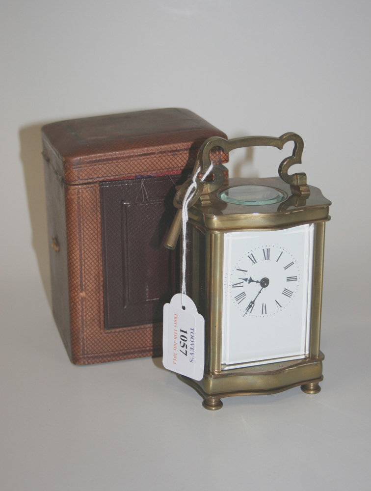 A late 19th/early 20th Century French brass cased carriage timepiece, the white enamel dial with