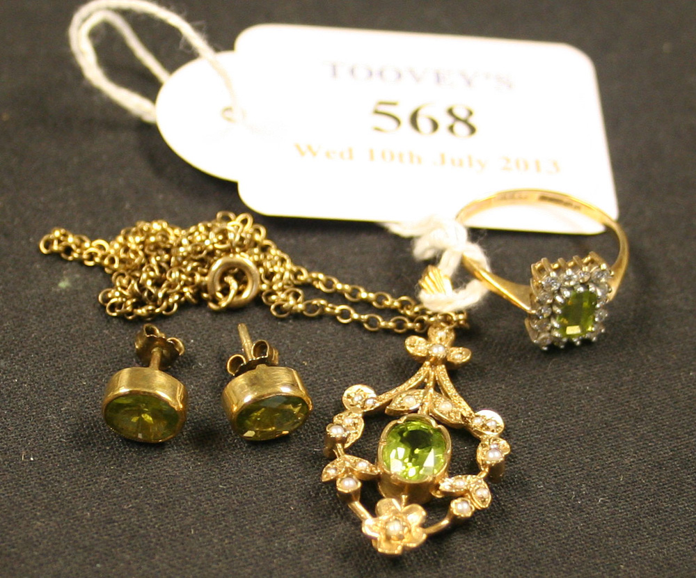 A 9ct gold, peridot and seed pearl set pendant in a pierced floral and foliate design, with a 9ct