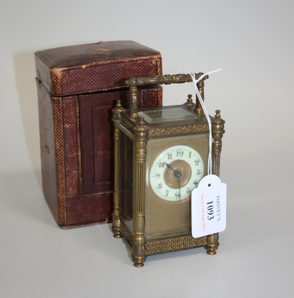 A late 19th/early 20th Century brass cased carriage timepiece, the enamel chapter ring with Arabic