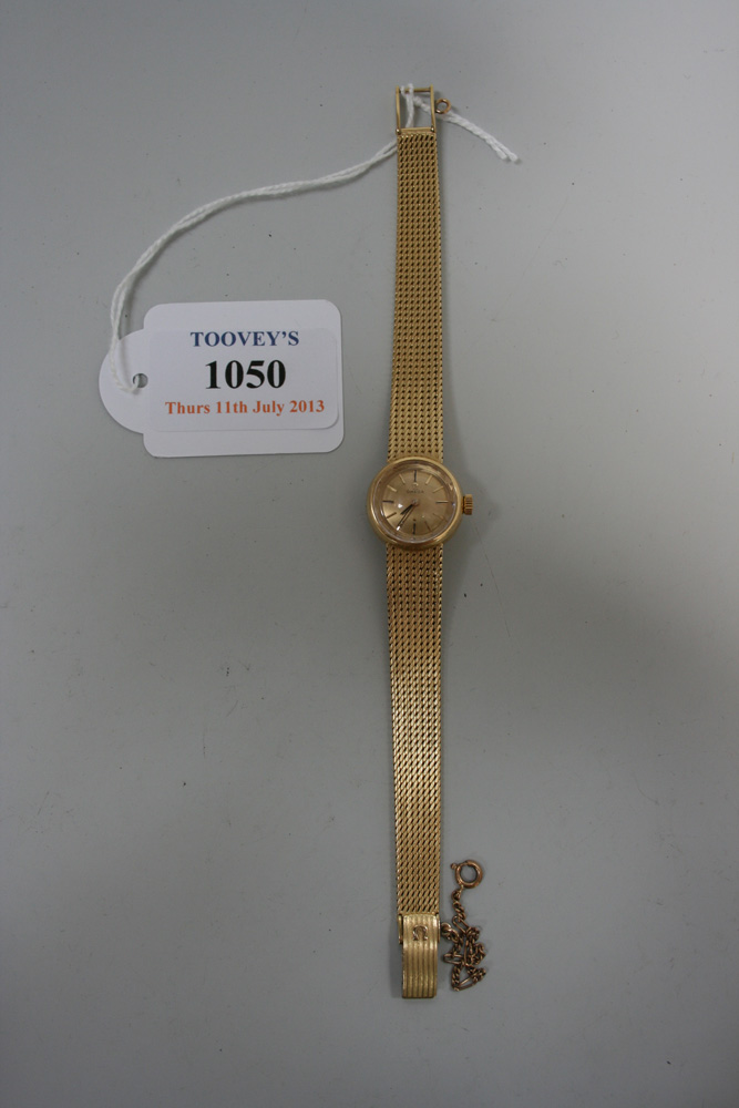 An Omega 18ct gold lady`s bracelet wristwatch, the signed circular gilt dial with baton numerals and