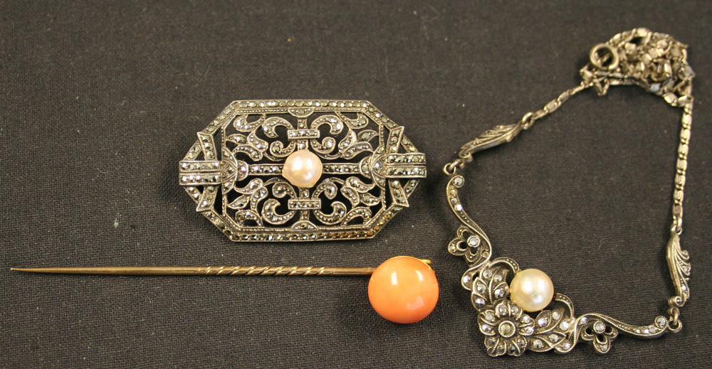 A gold and coral set stick pin, mounted with a circular coral, a marcasite and cultured pearl set