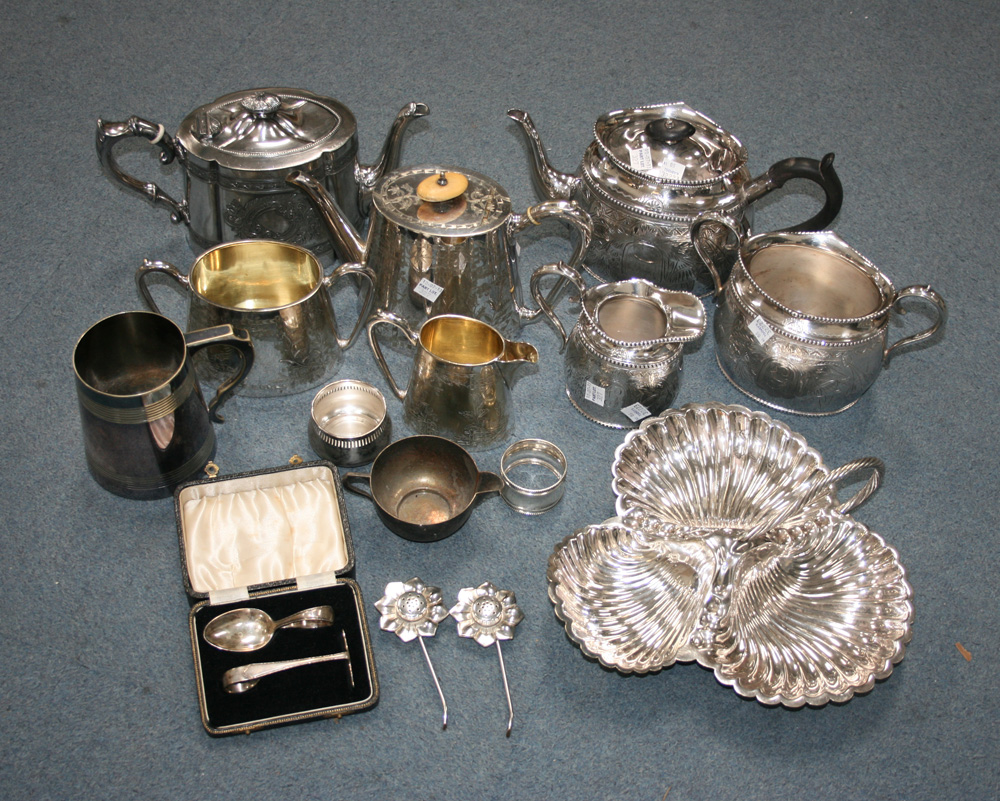 A late Victorian plated three piece tea set of oval form with engraved decoration, comprising