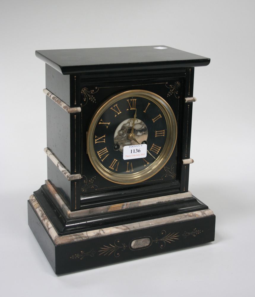 A late 19th Century slate and grey marble mantel clock with eight day movement striking on a gong,