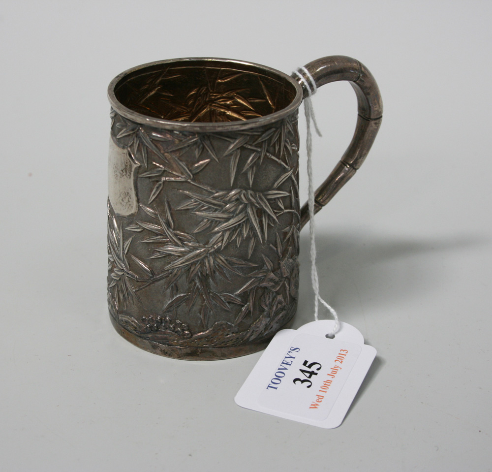 An early 20th Century Chinese silver tankard with simulated bamboo handle, the tapered cylindrical