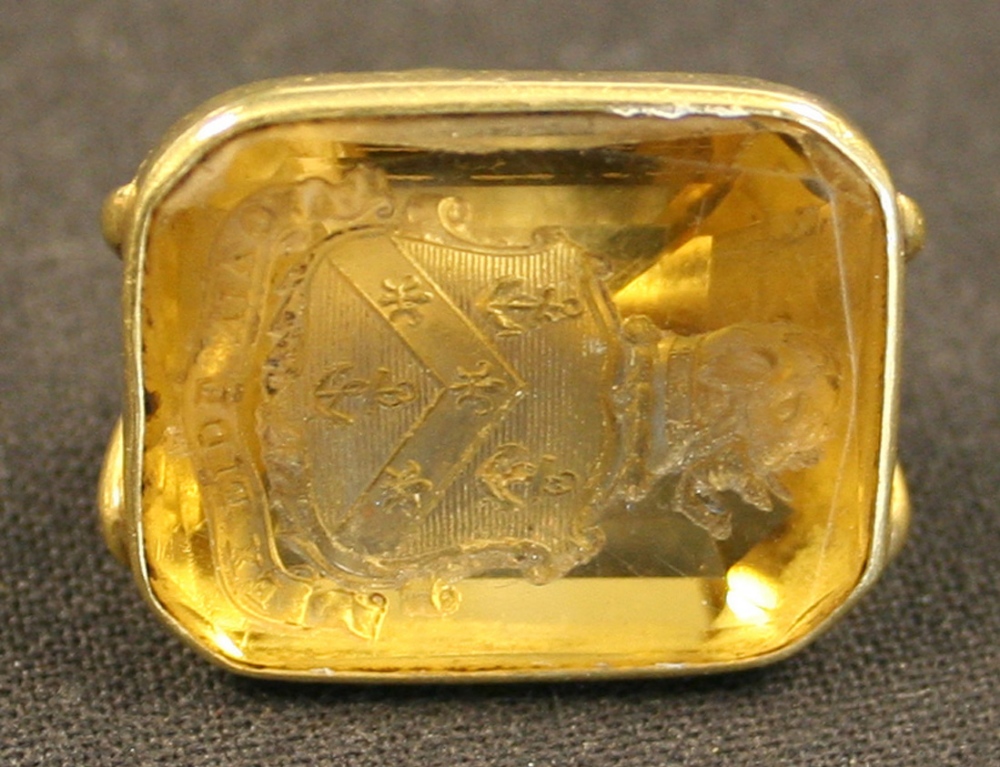 A gold mounted citrine set pendant fob seal, engraved with a shield, crest and motto.