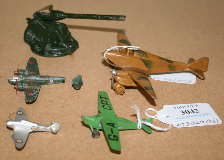 A Dinky Toys monoplane, finished in green, a Hawker Hurricane, a Blenheim Bomber, a die-cast