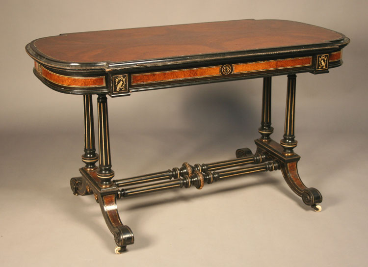 A late Victorian amboyna and ebonized centre table, the `D` end top with an applied beaded border