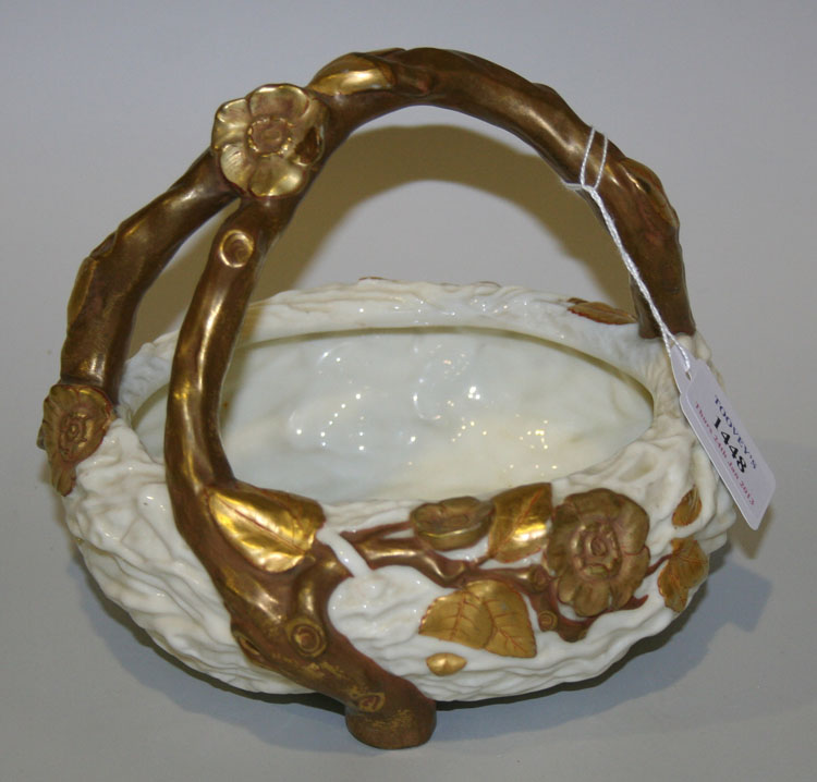A Royal Worcester porcelain white glazed and gilt rustic basket, late 19th Century, the overhead