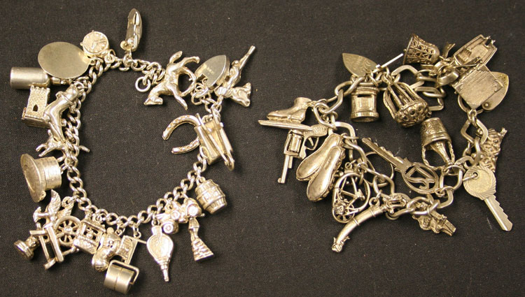 A silver curblink charm bracelet with a heart shaped padlock clasp, fitted with a variety of charms,