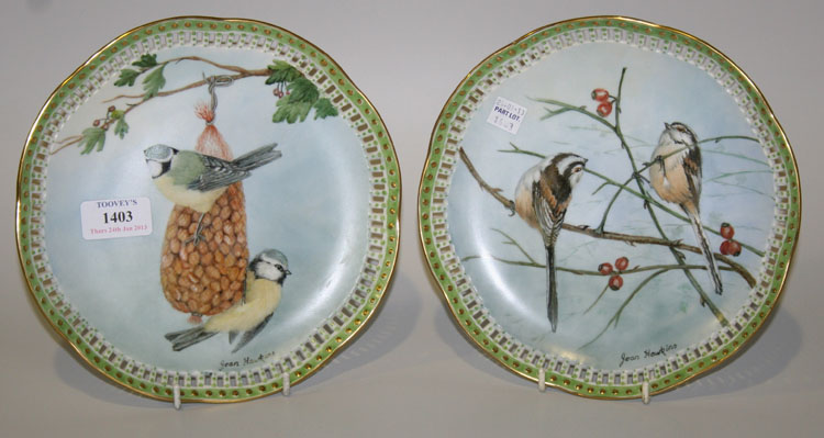 A pair of pierced porcelain plates painted by Joan Hawkins, signed, dated 1985, the first with two