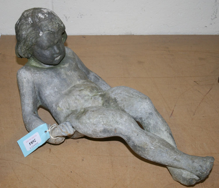 A late 19th Century cast lead garden figure of a naked boy, seated with his legs crossed, length