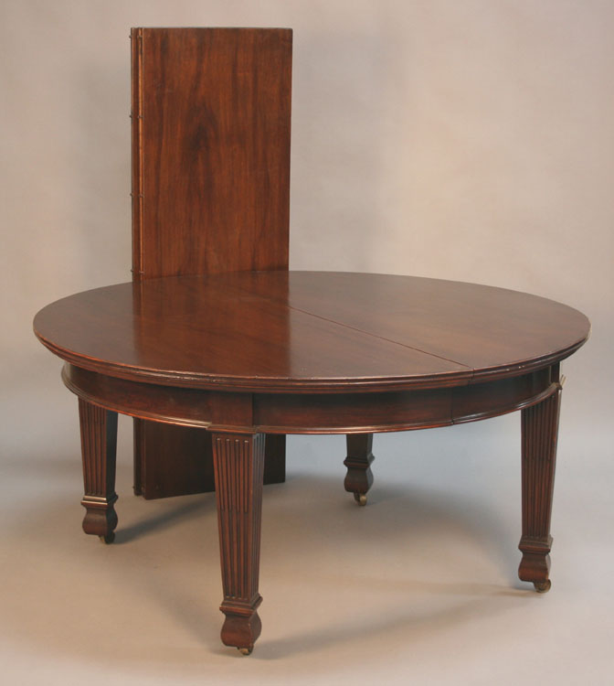 A large late Victorian mahogany extending dining table, the moulded top with three extra leaves