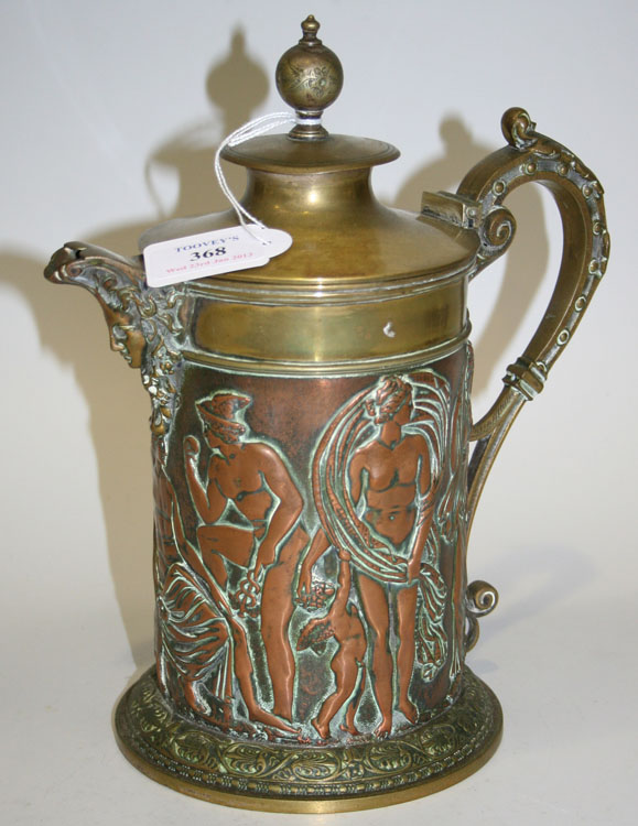 A late Victorian copper and brass jug with hinged lid, the copper cylindrical body decorated in