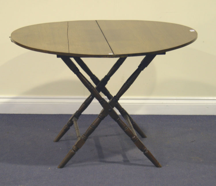 An early 20th Century mahogany folding table, the circular top on turned and block legs, diameter