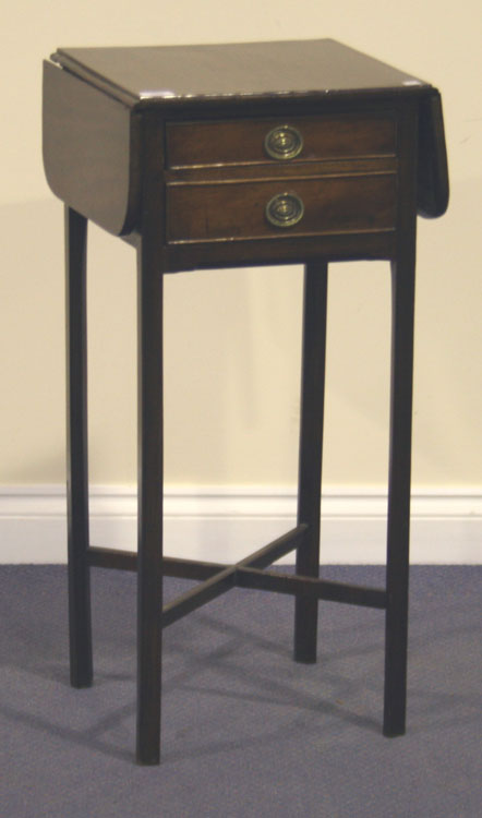 A George V mahogany work table, fitted with two drawers and fall flaps, on block legs.