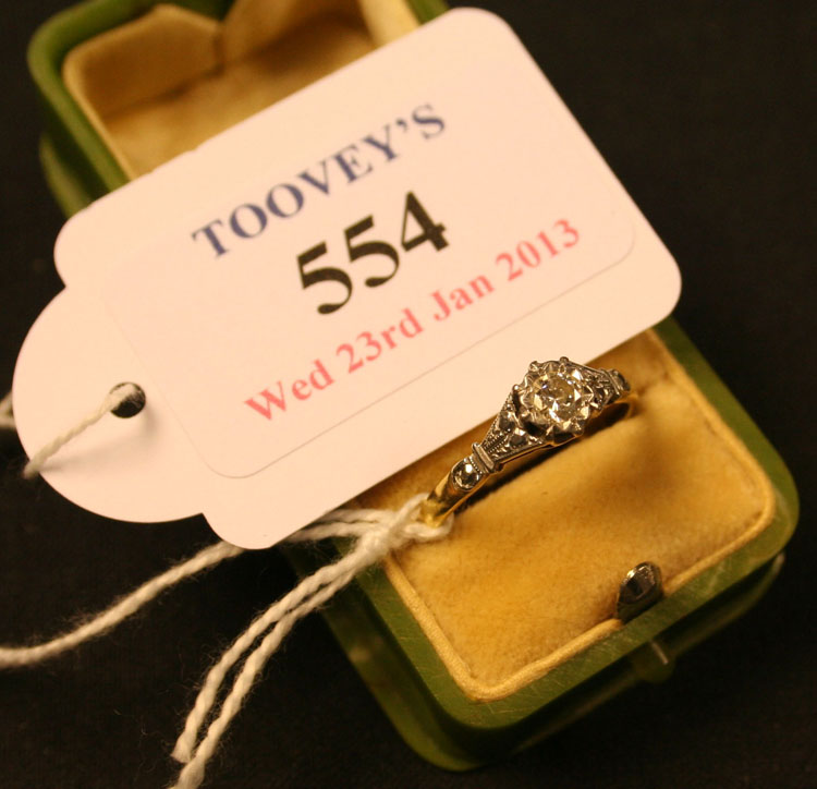 An 18ct gold and diamond set single stone ring, mounted with a circular cut diamond between