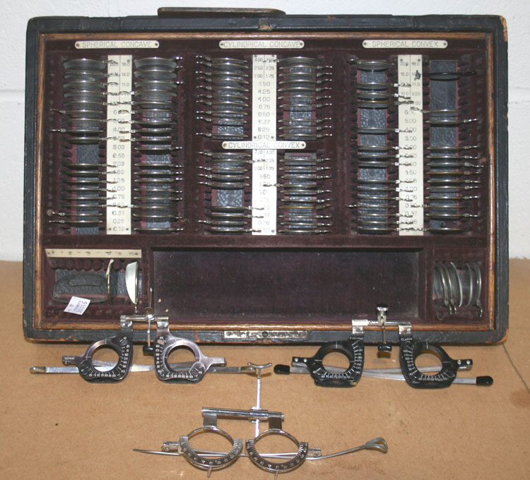 A cased set of optician`s lenses, including spherical concave, cylindrical concave and spherical