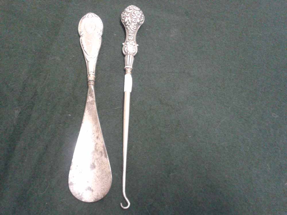 A hallmarked silver ladies button hook and shoe horn