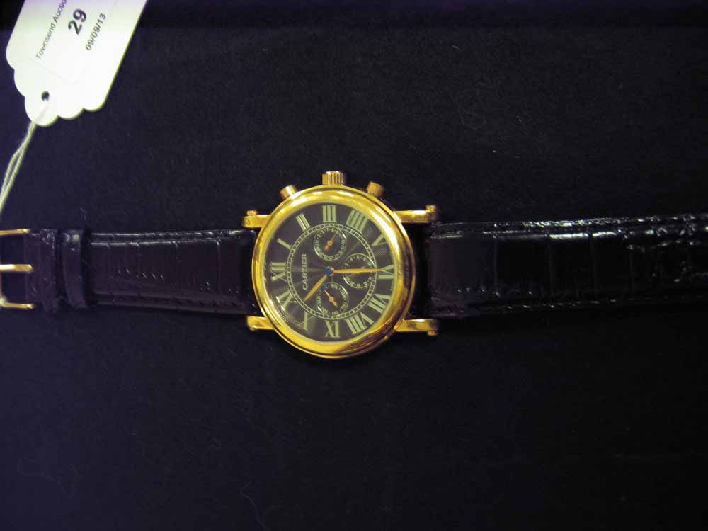 A replica Cartier black & gilt mens wristwatch with day date & month dials